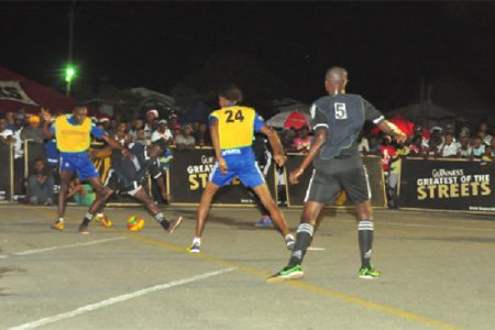Devon Millington of Sparta Boss (left) tussling with Travis Grant (second left) of North Ruimveldt for possession of the ball during their team’s semi-final showdown while Cleon Forrester (no.24) and Rickford James (no.5) look on.
