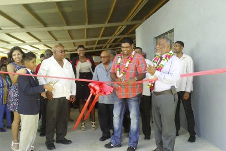 Minister of Tourism, Industry and Commerce, Irfaan Ali (second from right) and David Safeek( second from left) cut the ribbon as the Prime Minister, Samuel Hinds (front right) and other guests looks on.