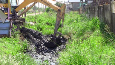 The excavator when it was used to clean the trenches in Sheet Anchor Village East Canje in August