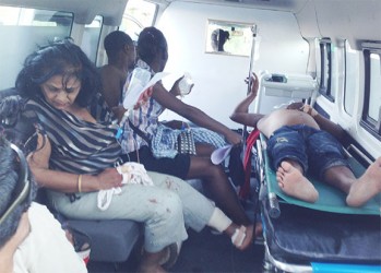 The driver of the car (at right) and other passengers about to be transferred to the Georgetown Public Hospital