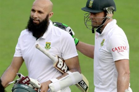 Hashim Amla and AB de Villiers leave the field at Centurion yesterday after hitting unbeaten centuries on the way to their unbroken record fourth wicket stand.