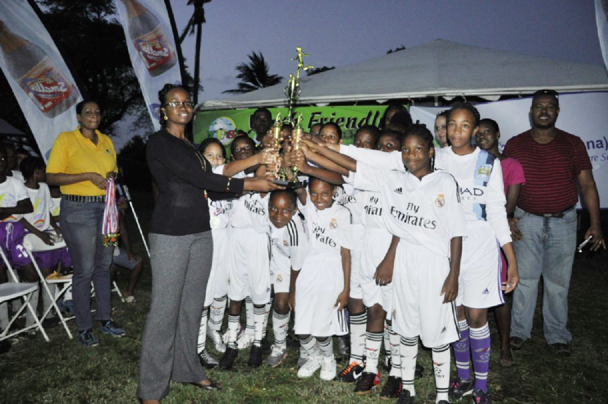 Stella Maris Primary receiving their championship trophy from Ministry of Health Representative Dr. Ertenisa Hamilton following the conclusion of the event’s finale