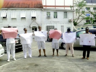 (From left) Sharon Chase, Sandra Hanover and other colleagues protesting inside the City Hall compound yesterday.  