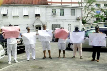 (From left) Sharon Chase, Sandra Hanover and other colleagues protesting inside the City Hall compound yesterday.  