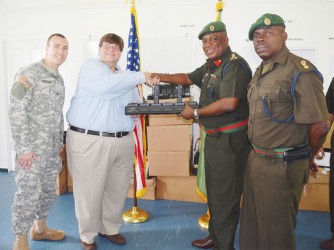 US Embassy Chargé d’ Affaires Bryan Hunt (second from left) making the presentation to GDF Chief of Staff, Brigadier Mark Phillips. (US Embassy photo) 