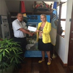 IDB Representative Sophie Makonnen (right) and Damian Chambers of the Paruima at the handing over of the grant. (IDB photo) 