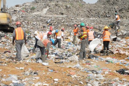 Waste pickers sorting through garbage for recyclable materials