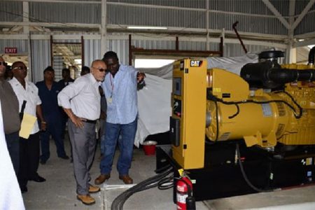 President Donald Ramotar being given a tour of the generating sets at the commissioning of the 24-hour service at the Leguan Power Station. (GINA photo)