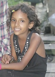 Varshanie Ramdas sits on a landing.  