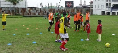 Members of the Georgetown Football Club (GFC) junior teams being put through the paces by team manager Faizal Khan (left) during a training session at the club’s Bourda locale