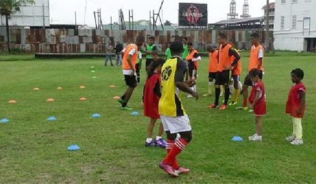 Members of the Georgetown Football Club (GFC) junior teams being put through the paces by team manager Faizal Khan (left) during a training session at the club’s Bourda locale