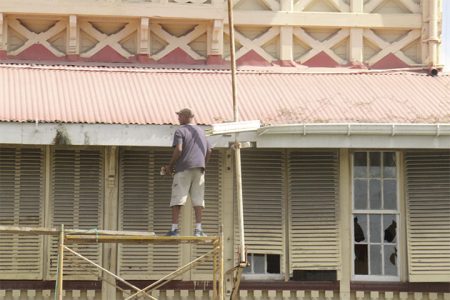 Worker replacing the gutters along the roof of the High Court yesterday. (Photo by Arian Browne)