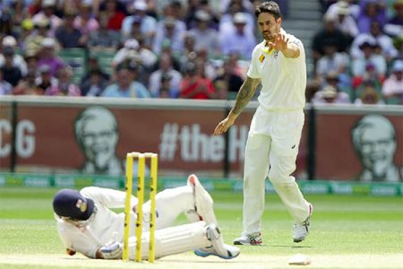  Australia’s  Mitchell Johnson apologises for throwing the ball and hitting India’s Virat Kohli in the back.
