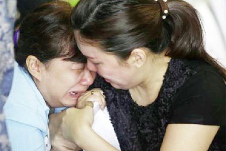 Family members of passengers onboard missing AirAsia flight QZ8501 cry at a waiting area in Juanda International Airport, Surabaya December 29, 2014. (Reuters/Bea Wiharta)
