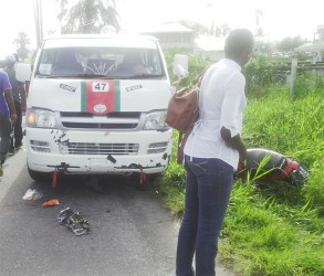 A passerby examining the damage following the accident yesterday morning on Croal Street, just off of Oronoque Street.