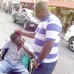 Images taken from the video that went viral on Monday on Facebook showing a policeman slapping a wheelchair-bound man and a policewoman shoving the man down a street.  
