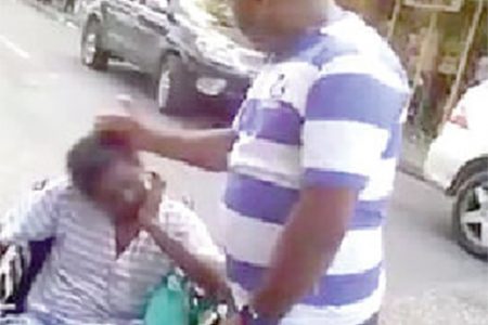 Images taken from the video that went viral on Monday on Facebook showing a policeman slapping a wheelchair-bound man and a policewoman shoving the man down a street.
