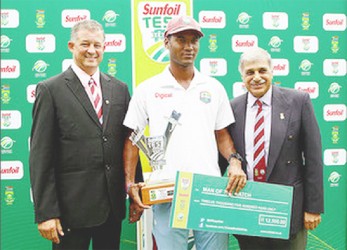 Kraigg Brathwaite collects his Man of the Match award and cheque at the end of the second Test match against South Africa at St George’s Park in Port Elizabeth yesterday. WICB Media Photo 