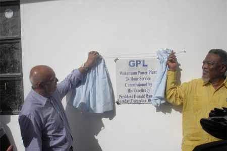 President Donald Ramotar (left) and Prime Minister Samuel Hinds unveil the plaque.

