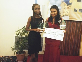 Stabroek News reporters Jeanna Pearson (right) and Desilon Daniels who won for the ‘Best Feature Story’ and second place for ‘Best News Story’ respectively in the PAHO Media Awards for Excellence in Health Journalism pose with their prizes after the ceremony at the Pegasus Hotel on Saturday night.