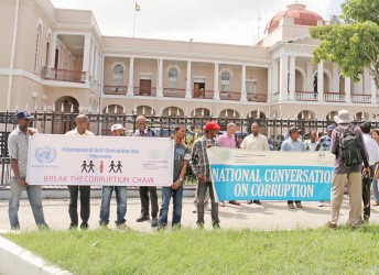 The marchers held banners outside of Parliament