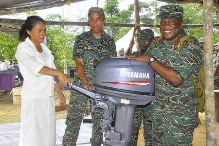 Chief of Staff Brigadier Mark Phillips (right) handing over the outboard engine. (GDF photo)