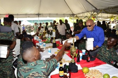 President Donald Ramotar sharing meals to junior ranks of the Guyana Defence Force at Camp Stephenson, Timehri (GINA photo)
