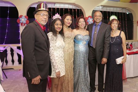 President Donald Ramotar (left) and the First Lady Deolatchmee Ramotar (right) pose with Police Commissioner Seelall Persaud (second from right) and family at the Police Officers Mess.