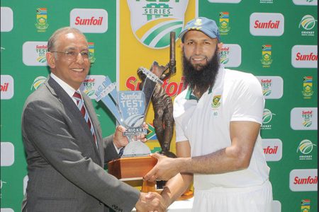 South Africa skipper Hashim Amla receives the trophy for winning the series against the West Indies from Haroon Lorgat at the end of the fifth day of the 3rd Test between South Africa and West Indies at Sahara Park Newlands yesterday in Cape Town, South Africa. (Photo by Carl Fourie/Gallo Images)