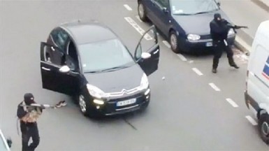 Gunmen flee the offices of French satirical newspaper Charlie Hebdo in Paris, in this still image taken from amateur video shot on January 7, 2015, and obtained by Reuters. REUTERS/Handout via Reuters TV 
