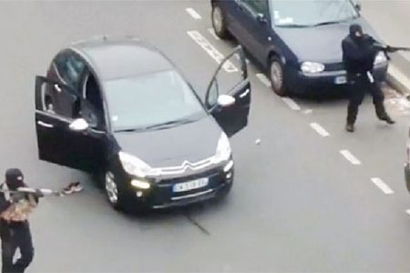Gunmen flee the offices of French satirical newspaper Charlie Hebdo in Paris, in this still image taken from amateur video shot on January 7, 2015, and obtained by Reuters. REUTERS/Handout via Reuters TV
