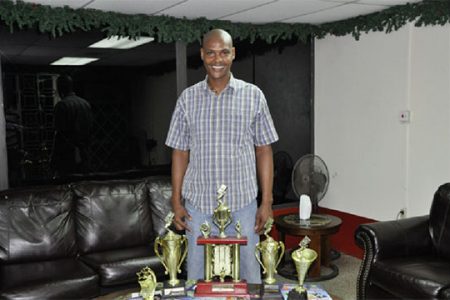 Organiser Lyall Gittens display the trophies up for grabs this Sunday in the August Beverages/ Untouchable Boss dominoes tournament.
