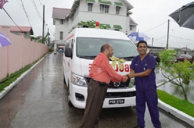 Minister of Health Dr. Bheri Ramsaran (left) handing over the keys to the new ambulance to Director of the Accident and Emergency Department, Dr. Zulfikar Bux (GINA photo)