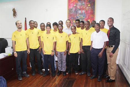 Minister of Culture, Youth and Sport, Dr Frank Anthony (centre) posing for a photo opportunity with the members of the National Junior Hockey Team following their return from Trinidad and Tobago
