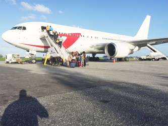 Have plane, will travel: Passengers boarding a Dynamic Airways flight at the Cheddi Jagan Inernational Airport earlier this week.