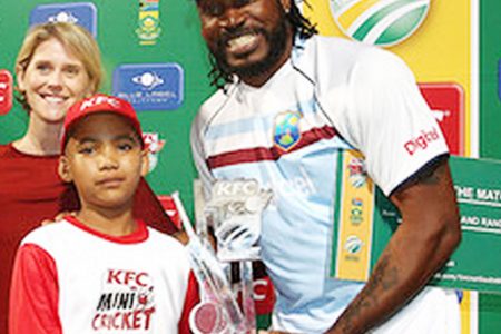 STILL THE MAN! Garth Strauss of the KFC Mini-Cricket hands Chris Gayle of the West Indies the Man of the Match Trophy after the first KFC T20 International match against South Africa at Sahara Park Newlands  yesterday in Cape Town, South Africa. (Photo by Shaun Roy/Gallo Images)