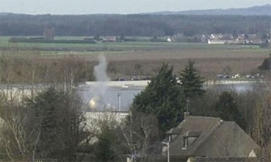 A flash of light and smoke appear, in this video grab, at the start of the final assault at the scene of a hostage taking at an industrial zone in Dammartin-en-Goele, northeast of Paris January 9, 2015. REUTERS/Reuters TV