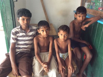 Boys waiting patiently to be attended to at a shop 