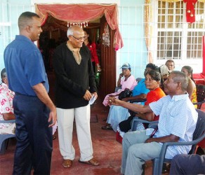 President of the NHF, Ramdular Singh (centre) and Boodnarine Persaud (left), local member/Traffic Chief of ‘B’ Division interacting with the old folks 