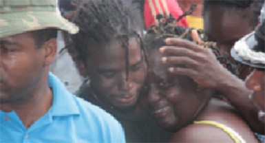 Relatives of one of the victims console each other at the scene on Monday.