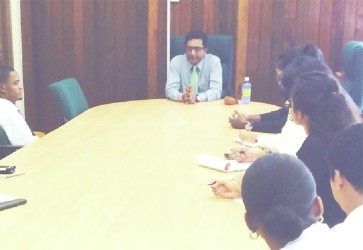 Attorney General Anil Nandlall (centre) speaking with law students at the Ministry of Legal Affairs boardroom (Ministry of Legal Affairs photo) 