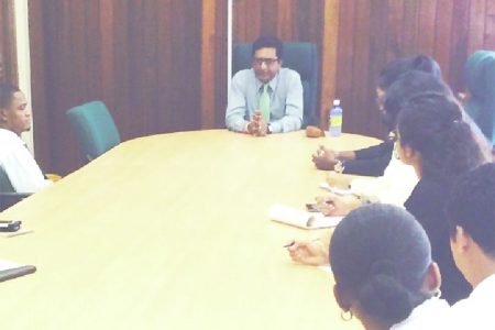 Attorney General Anil Nandlall (centre) speaking with law students at the Ministry of Legal Affairs boardroom (Ministry of Legal Affairs photo)
