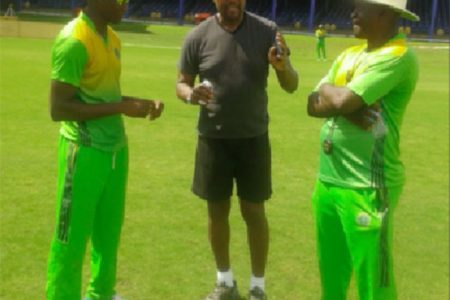 From left: Guyana Jaguars fast bowler Ronsford Beaton takes in a few pointers from ex West Indies pacer Colin Croft (middle) in the presence of head coach Esaun Crandon yesterday at the Queens Park Oval ground, Trinidad & Tobago ahead of today’s first match against the Windward Islands Volcanoes.
