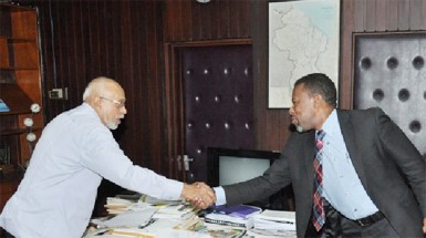 President Donald Ramotar (left)  greeting  Ronald Jackson, Executive Director, Caribbean Disaster Emergency Management Agency (GINA photo)