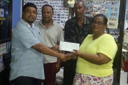 Faizal Ally (left), Managing Director of A. Ally and Sons presents a sponsorship cheque to BCB Secretary Angela Haniff, as Competition Committee Chair Carl Moore and Leslie Solomon look on. 