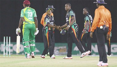 Guyana captain Christopher Barnwell shakes the hand of Shivnarine Chanderpaul after victory was achieved in  the Zone “A” match against the Windward Islands Volcanoes in the NAGICO Super50 Tournament on Thursday at Queen’s Park Oval. Photo by WICB Media/Ashley Allen 