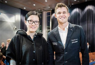 Two World Champions! Hou Yifan, 20, and Magnus Carlsen, 24, world chess champions, are pictured at the commencement of the Tata Steel Chess Tournament, which is currently underway in Wijk aan Zee, Netherlands. China’s Yifan, who is ranked 70th worldwide (2673), has entered the dynamic male arena of chess players. She opposed Carlsen (2862), ranked the No 1 chess player on the planet, yesterday. Both Carlsen and Yifan were beaten in previous rounds of the tournament. 