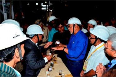 President Donald Ramotar  (right) and an official discussing production during his tour of the Valsad sugar factory (GINA photo) 