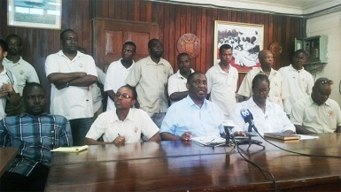 GPSU President Patrick Yarde, sitting at centre, speaking during the press conference on Friday, in the presence of GPSU officials and GGMC workers on strike. 