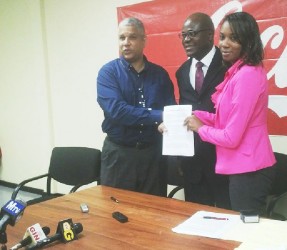 From left: Banks DIH Limited’s Sales and Marketing Executive Carlton Joao, Chief Education Officer Olato Sam and Deputy Permanent Secretary-Administration of the Ministry of Education Geneviève Blackman exchanging the signed Memorandum of Understanding. 